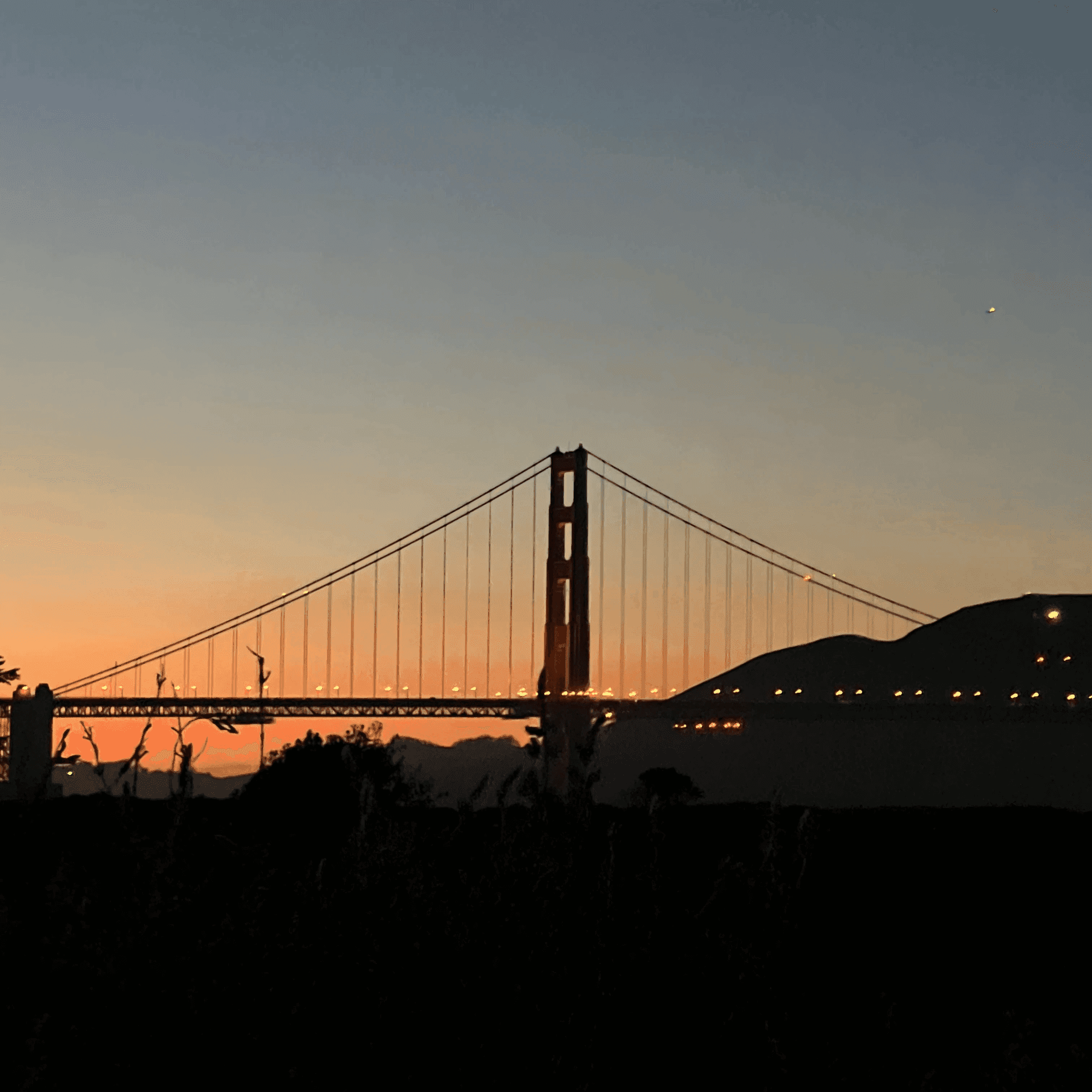 Golden Gate Bridge silhouetted at sunset