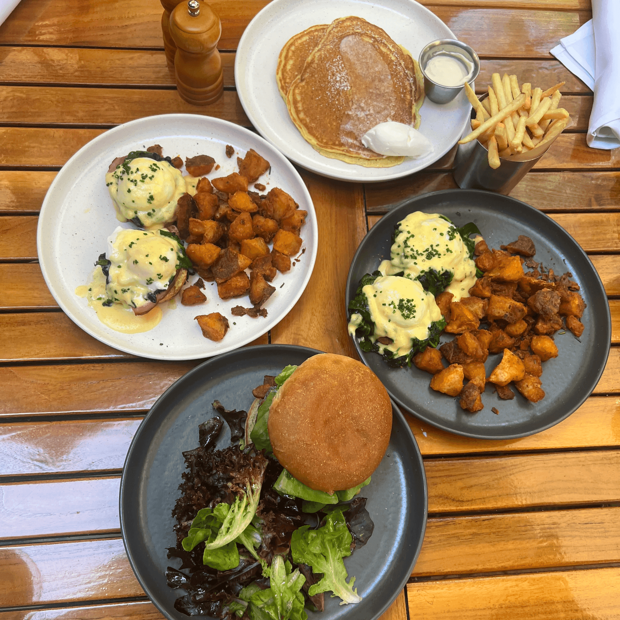 A wooden table covered with brunch plates