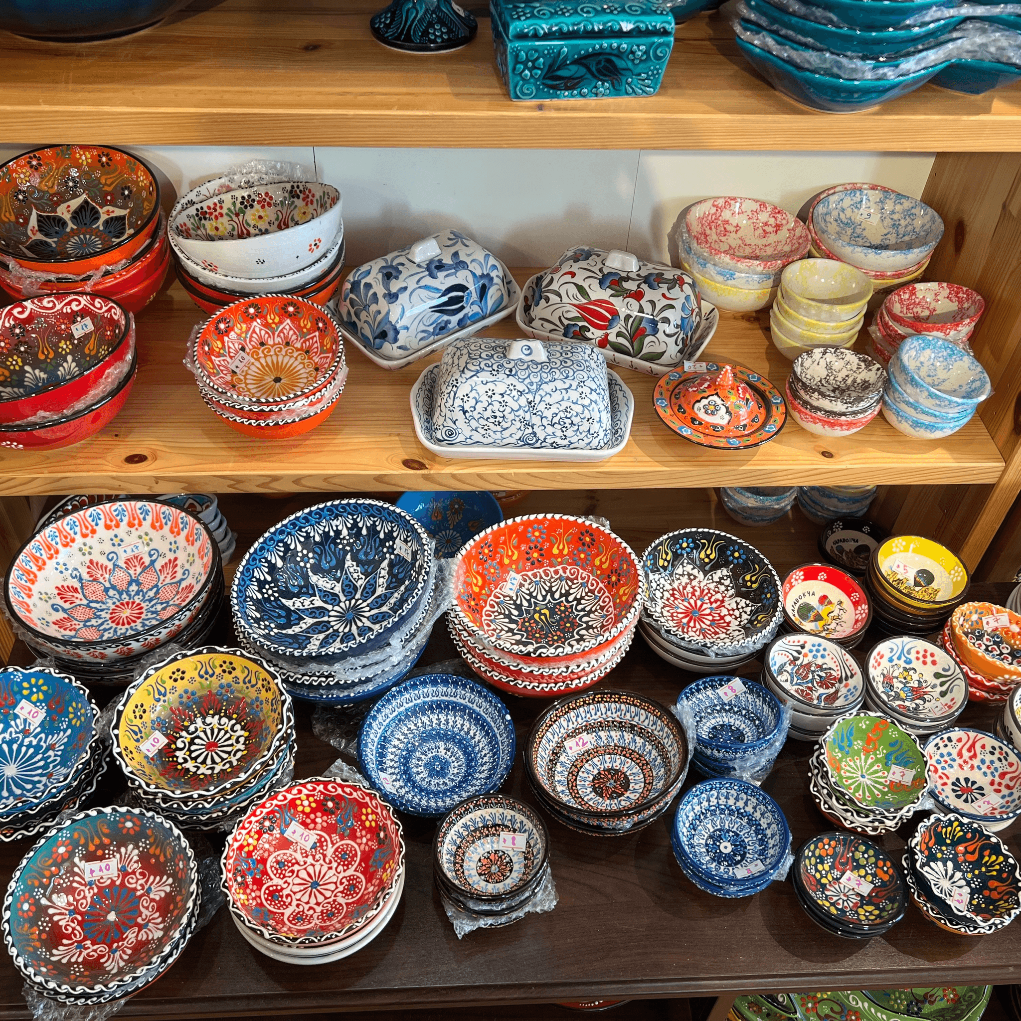Shelves of colorful hand-painted ceramic bowls